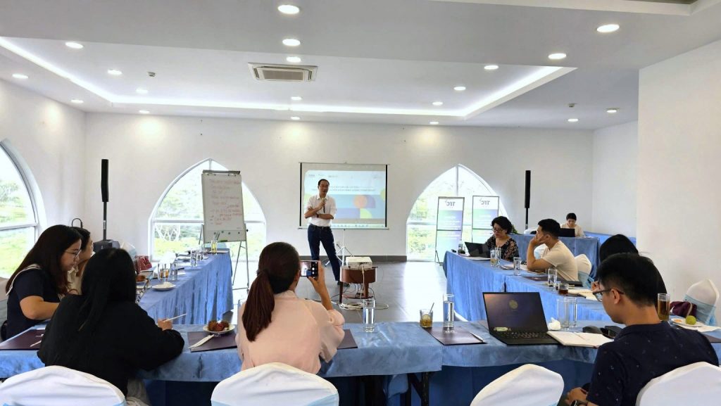 Presentation in a conference room with attendees seated and a presenter at the front.